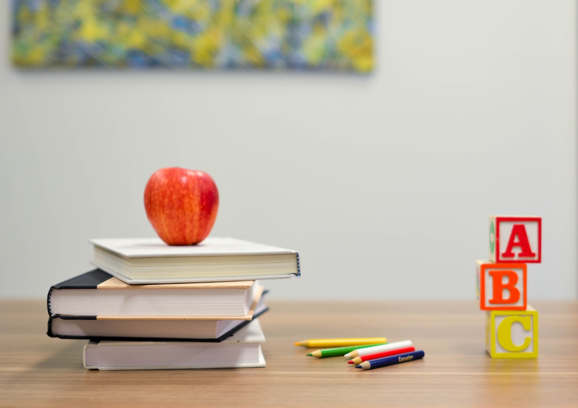 Apple on books with ABC blocks